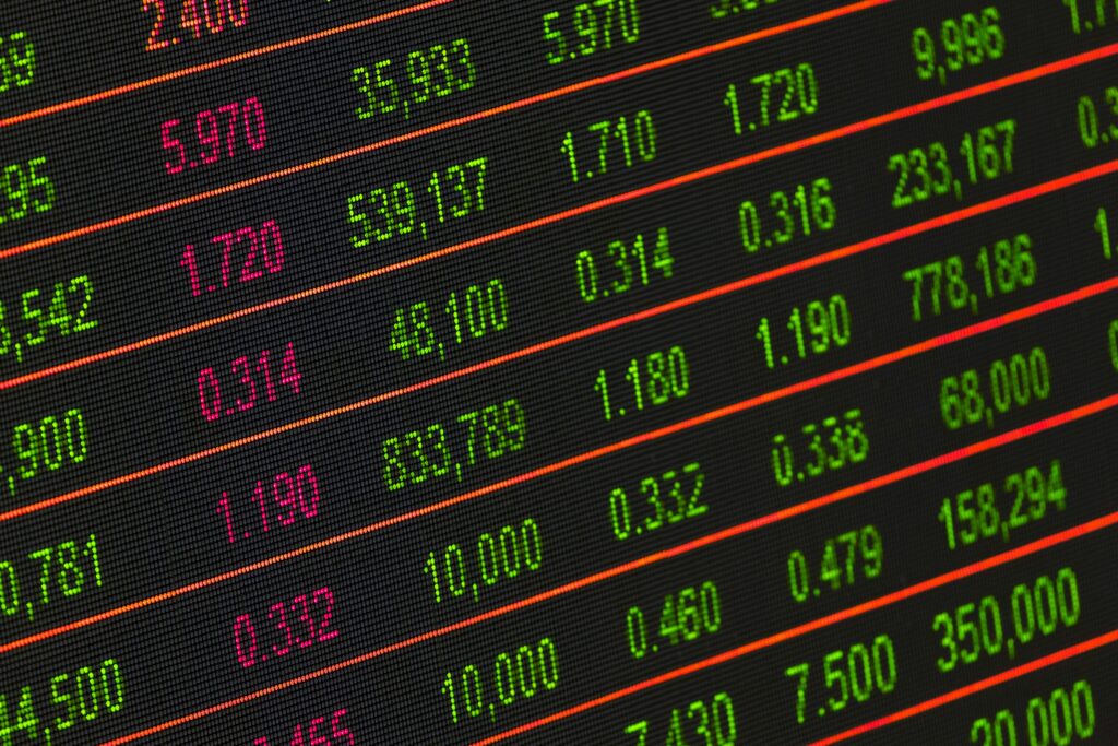 pexels-photo-210607-210607 Close-up of a digital stock market data display showing colorful financial numbers and trends.