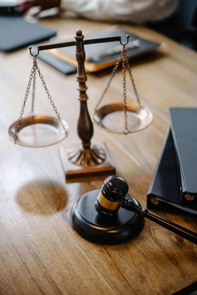 pexels-photo-5669619-5669619 A striking image featuring a brass justice scale and gavel on a wooden desk, symbolizing law and justice.
